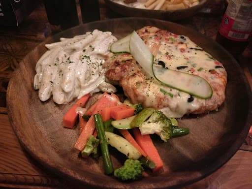 Sizzling flame-grilled chicken steak with mashed potatoes at Fire n Steakhouse Bahria Town Phase 7