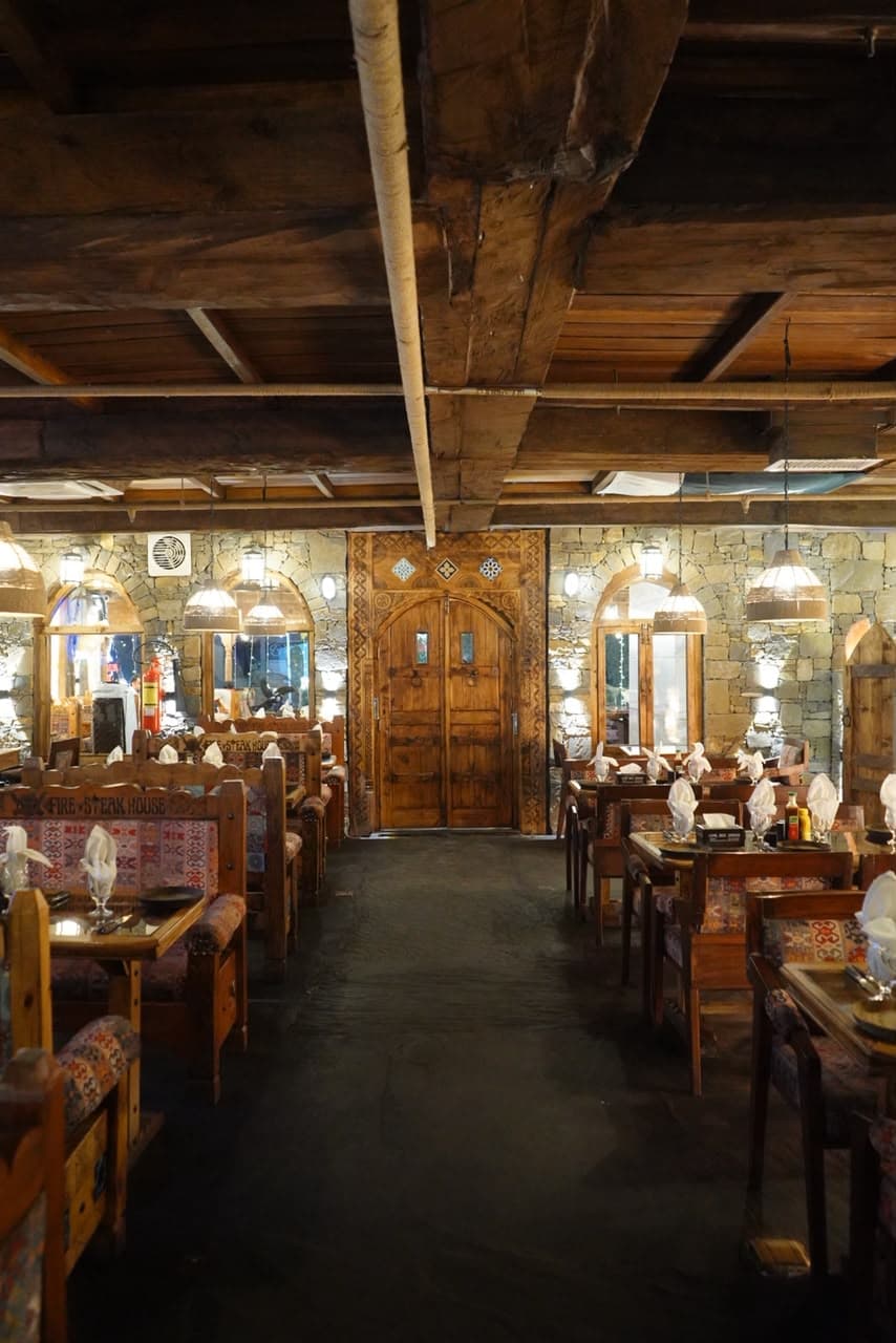 Warm ambient lighting and rustic stone decor at Fire n Steakhouse Bahria Town
